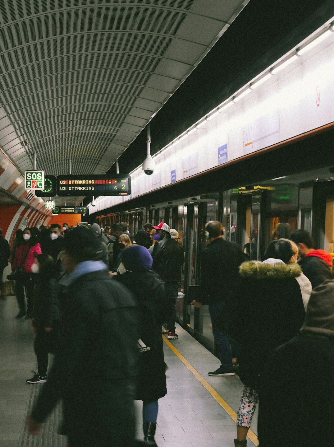 Commuters waiting on a crowded subway platform
